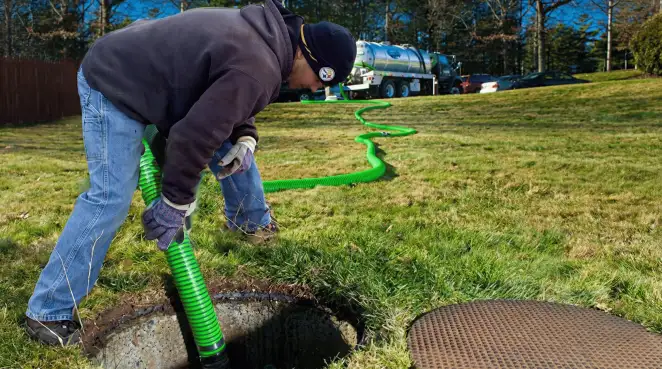 Service technician performing residential septic pumping and drainage maintenance in Honolulu, HI